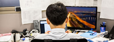 man at workstation image